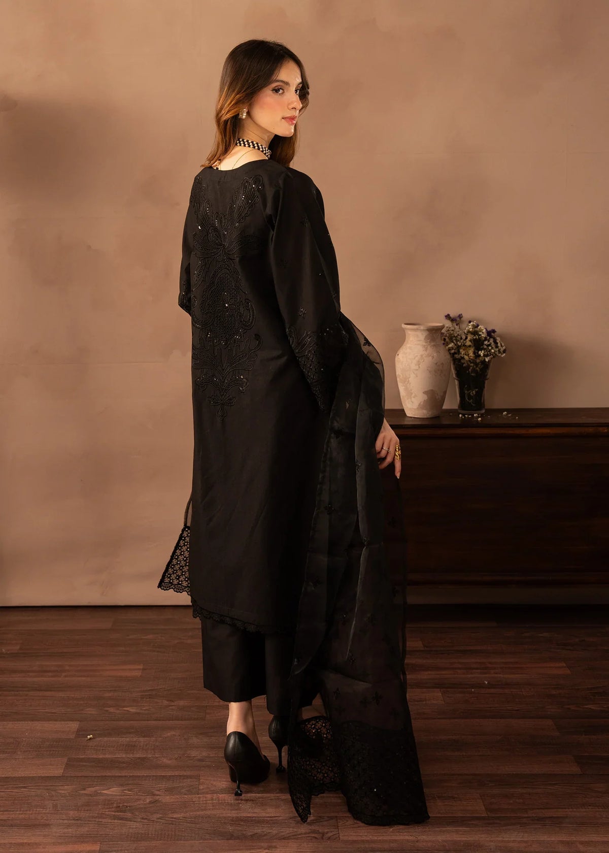 Women wearing black dress pakistani, close-up of the embroidery on the lawn shirt, Buraqstore