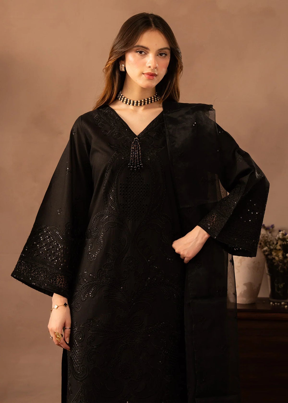 Model wearing black dress pakistani, side view showing the fit of the lawn shirt and trouser, Buraqstore