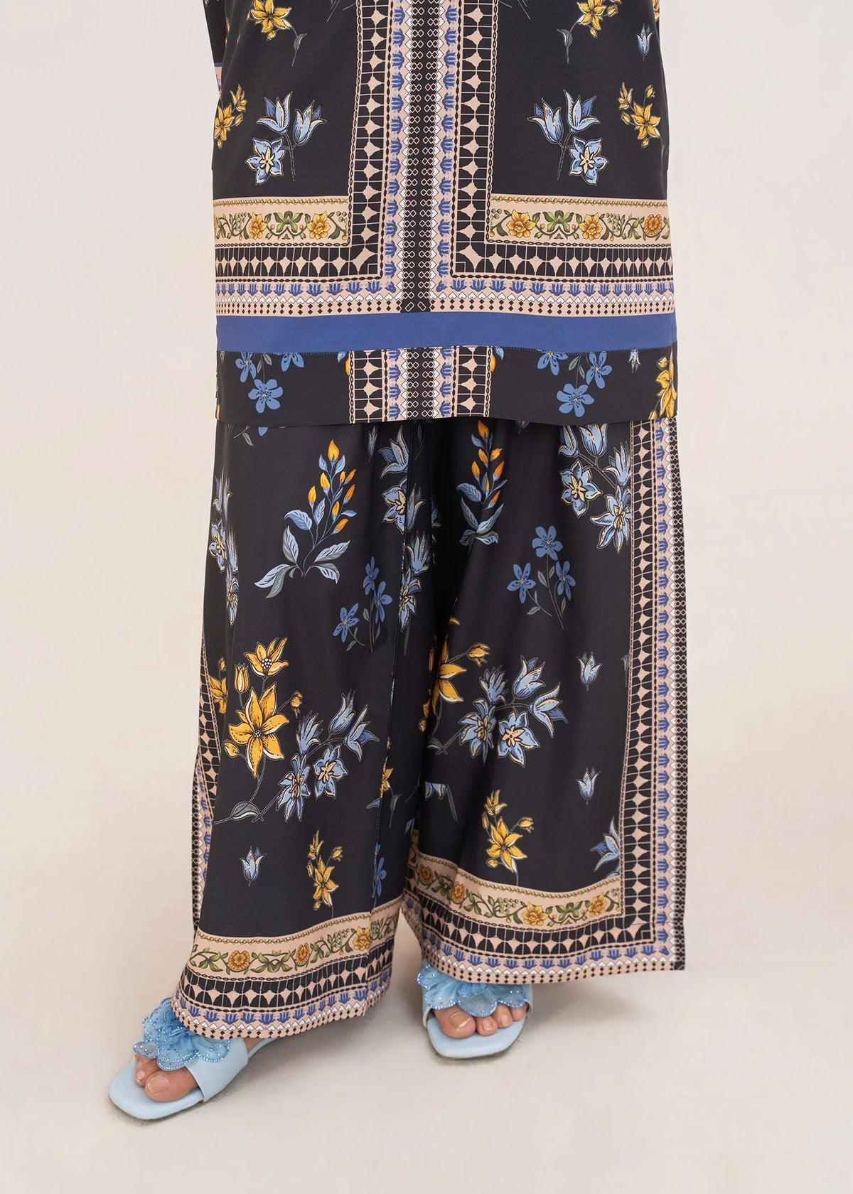 Model wearing black co ord set, close-up of the print on the grip top and bottom, Buraqstore