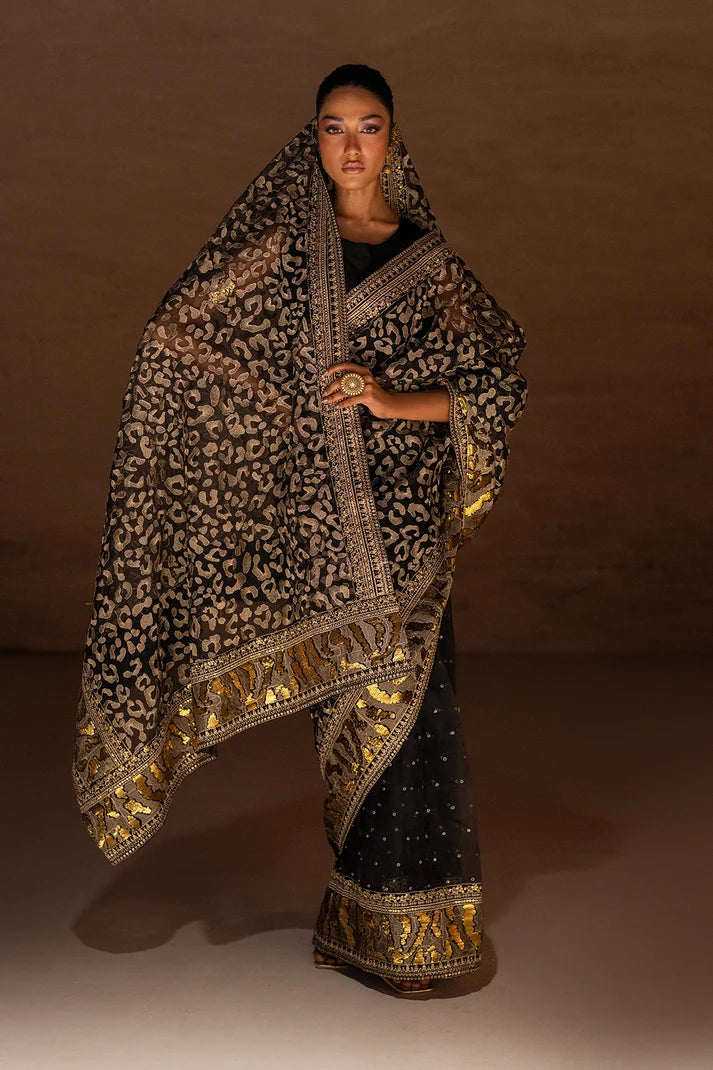 Women wearing black designer saree pakistan in organza with abstract metallic foil print, front view from Buraqstore