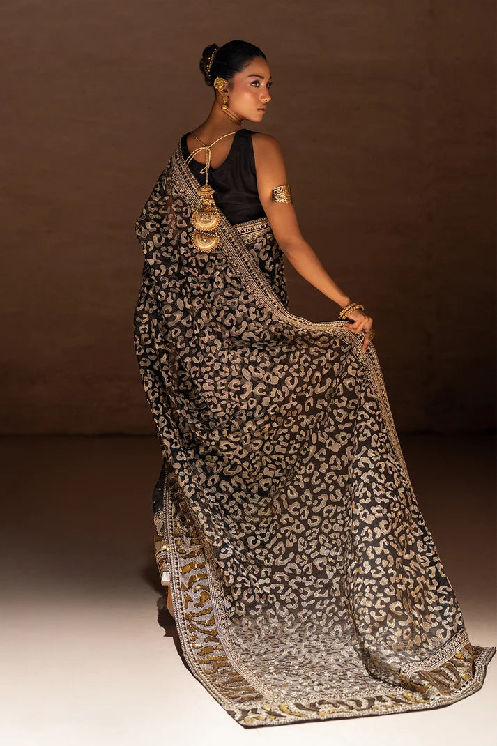 Model wearing black designer saree pakistan, close-up of the metallic foil print on the organza, Buraqstore