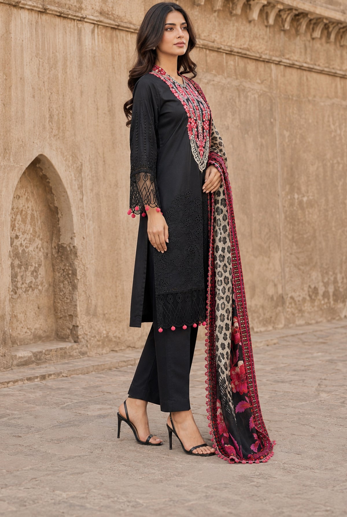 Model wearing black pakistani chikankari suits online with price set with plain dyed viscose trouser, side view at Buraqstore