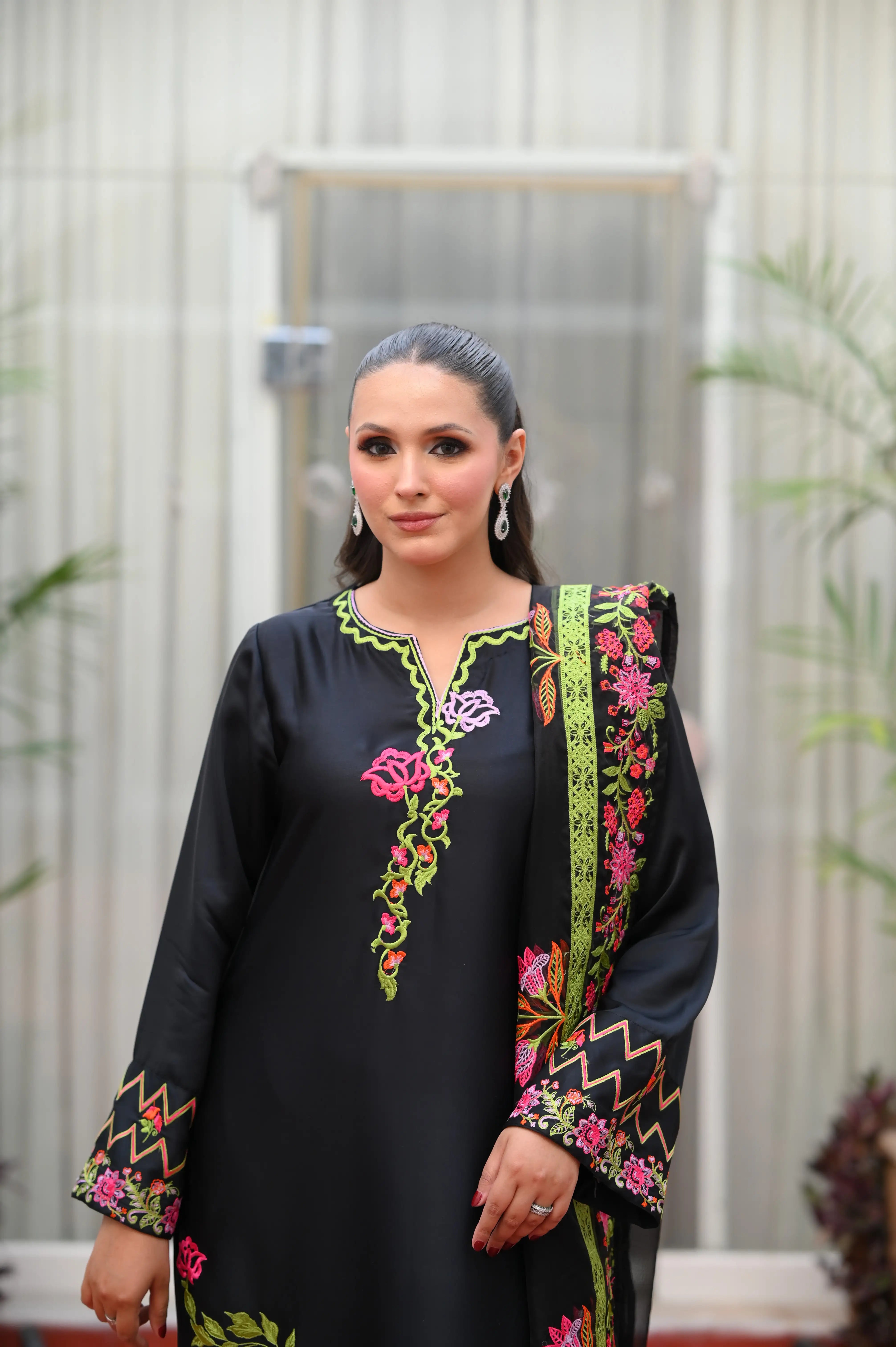 woman posing in Buraqstore silk 3PC outfit with black silk dress texture and premium festive appeal