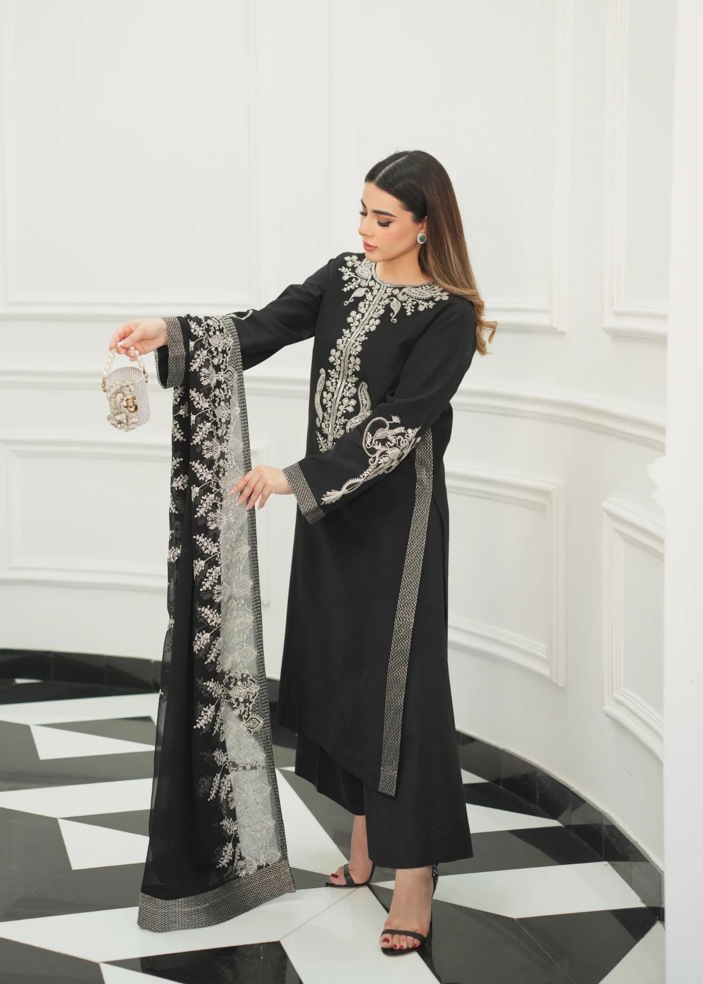 Model showcasing a black Jamnii Sheesha silk pret outfit at Buraq Store
