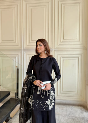 Model showcasing a black Jamnii silk 3 piece suit at Buraq Store