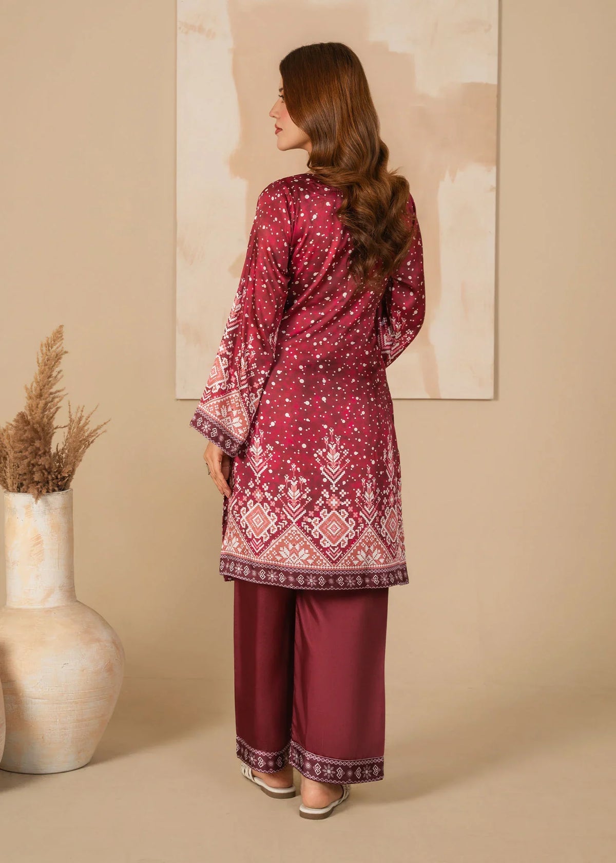 Women wearing blood red dress design, close-up of the print on the shamooz shirt, Buraqstore
