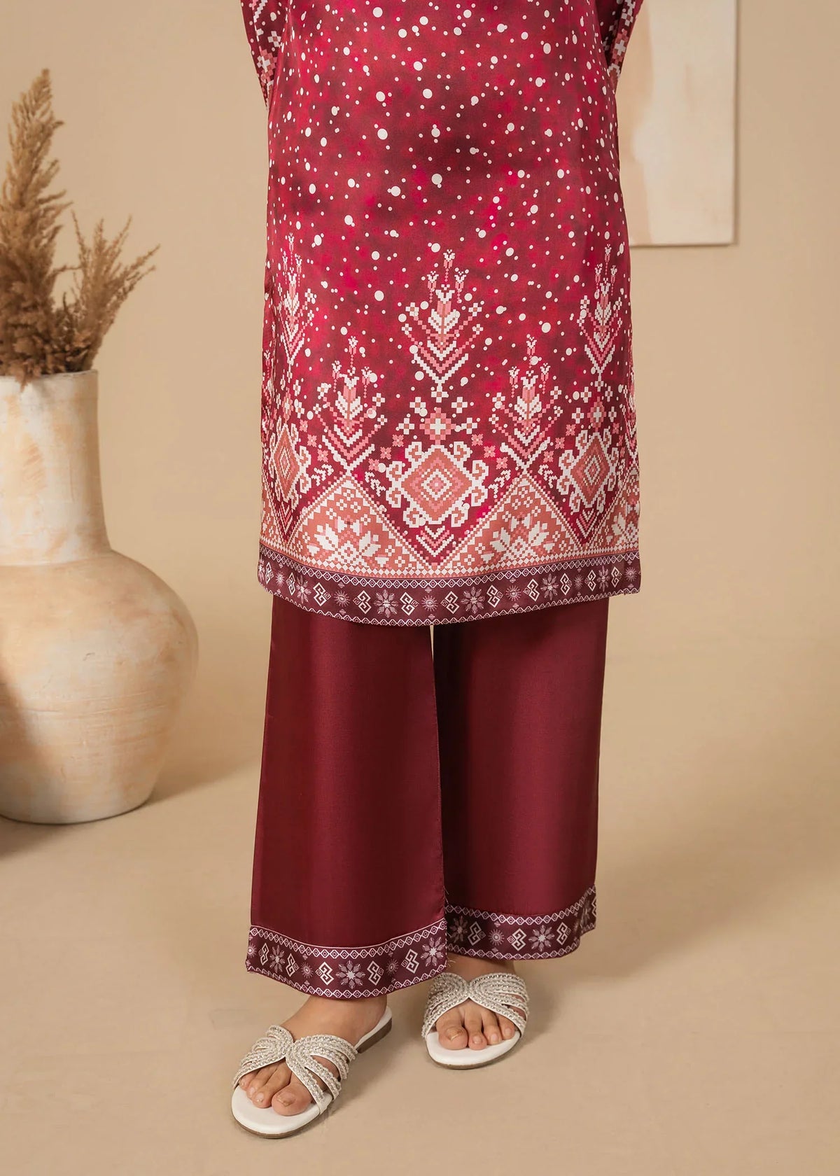 Model wearing blood red dress design, side view showing the fit of the printed shamooz 2PC, Buraqstore
