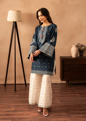 Model wearing blue dress design finished in white, embroidered lawn 2PC set, front view from Buraqstore