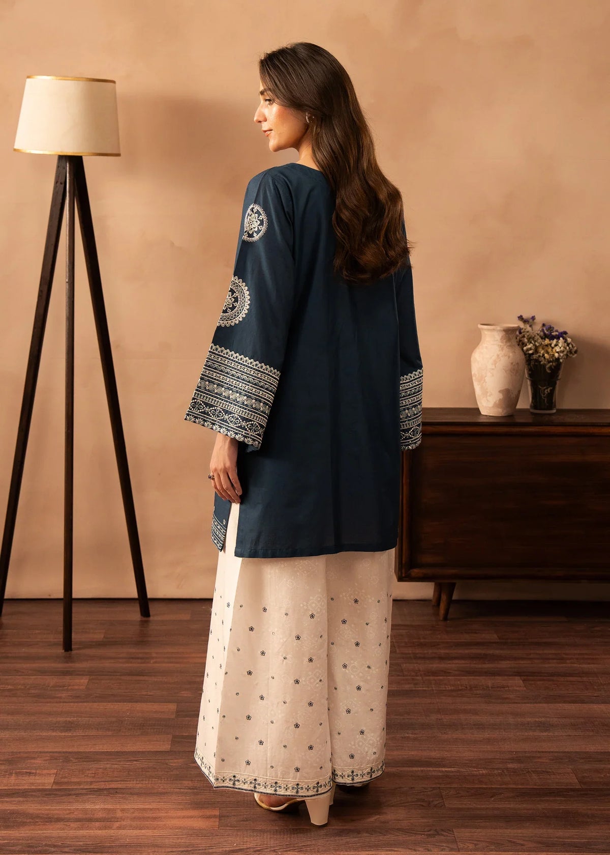 Women wearing blue dress design, close-up of the embroidery on the white lawn shirt, Buraqstore