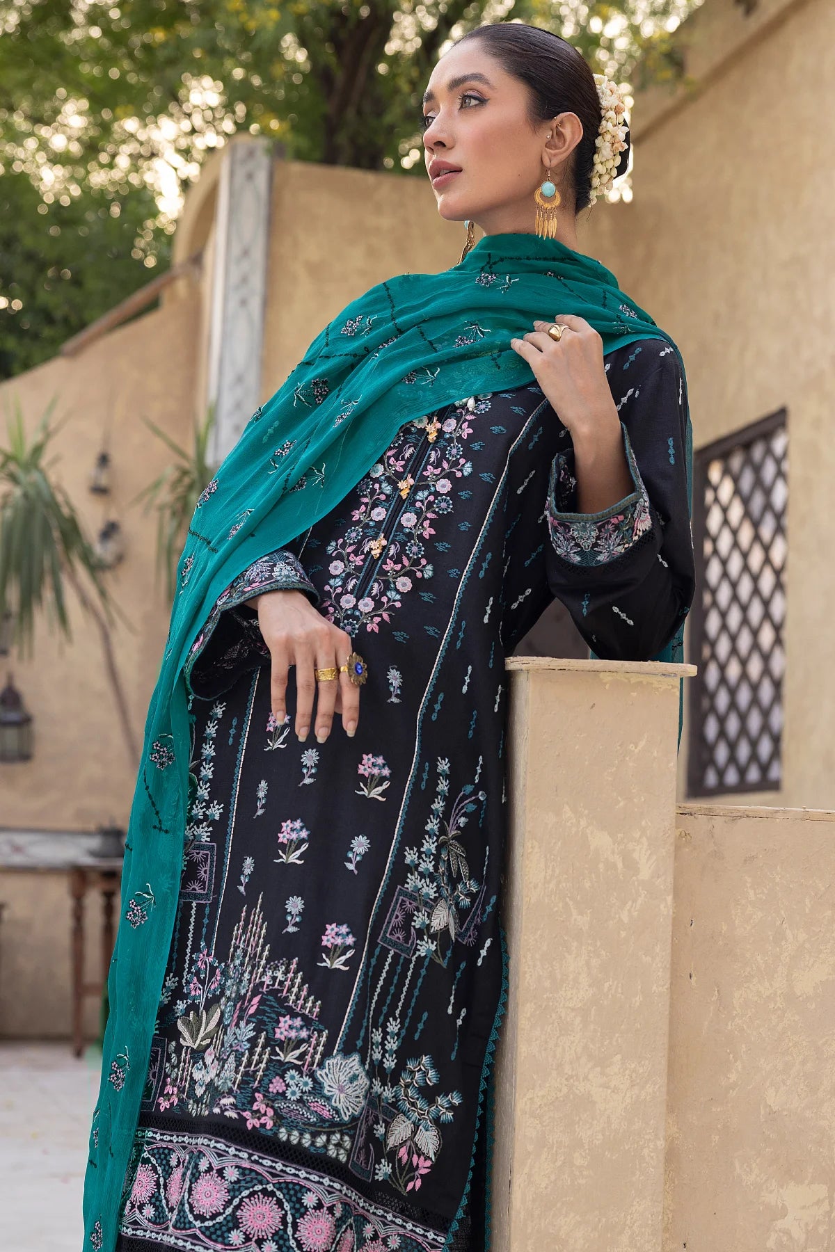 woman posing in buraqstore embroidered karandi suit to buy a black dress