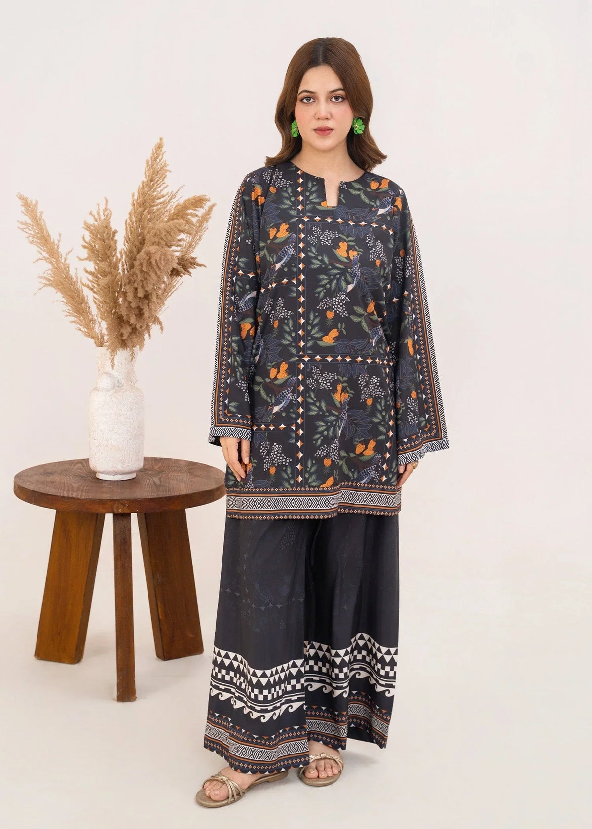 Model wearing black dress pakistan set in charcoal black, printed grip 2PC, front view from Buraqstore