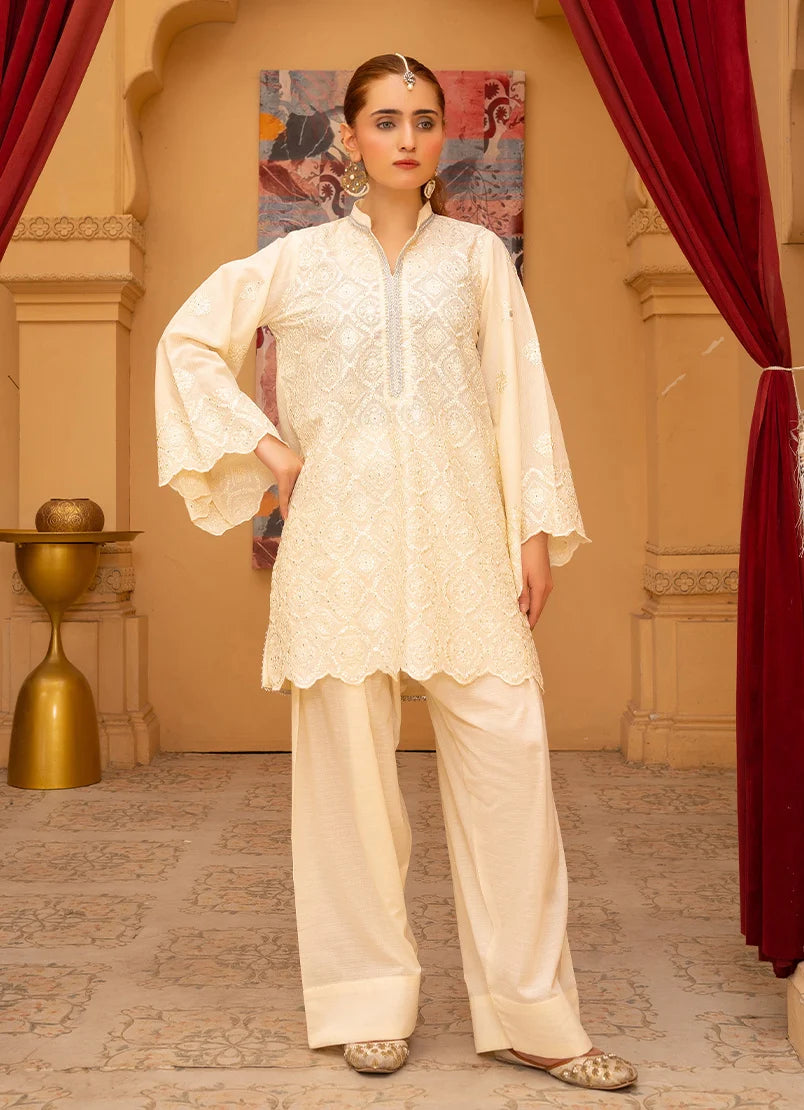 Model wearing cream color dress, embroidered bana dora fabric shirt and bottom, front view from Buraqstore