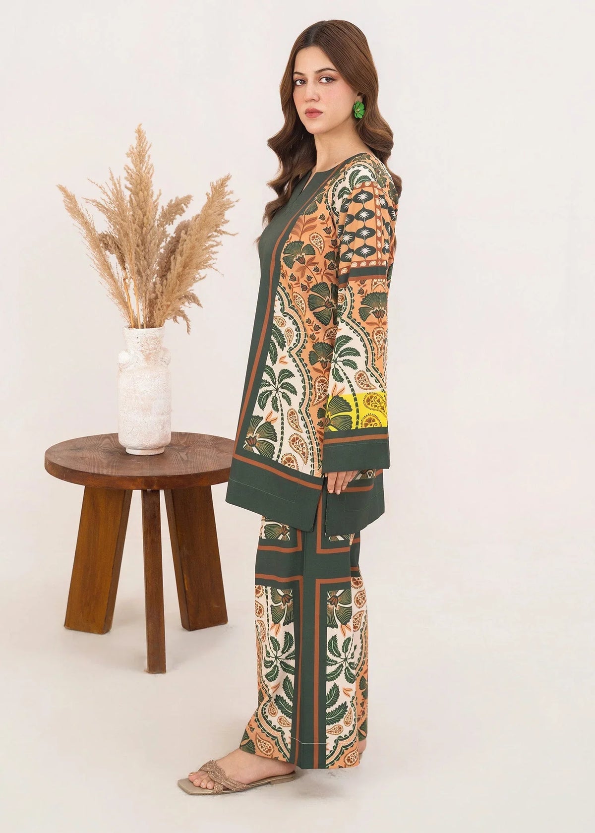 Model wearing dark green co ord sets Pakistan in a relaxed standing pose, printed poly lawn 2-piece at Buraqstore