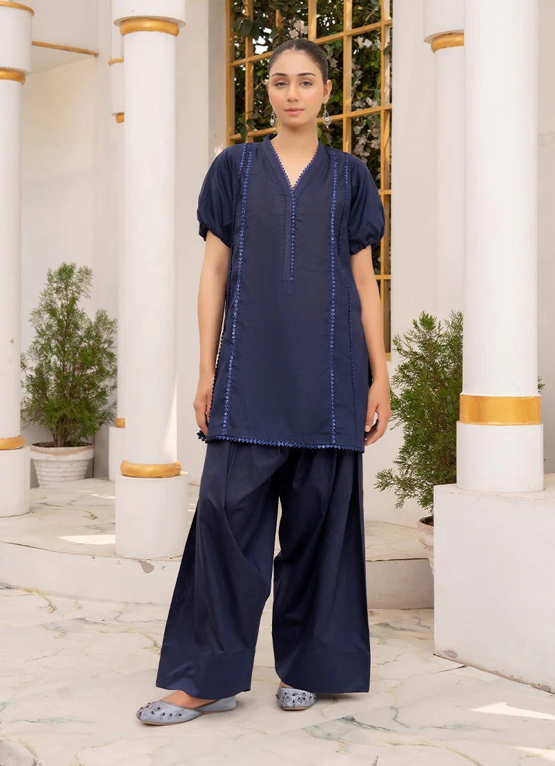 Model wearing navy blue color dress in deep navy, a cotton co-ord top and bottom with dori and lace detailing, front view from Buraqstore