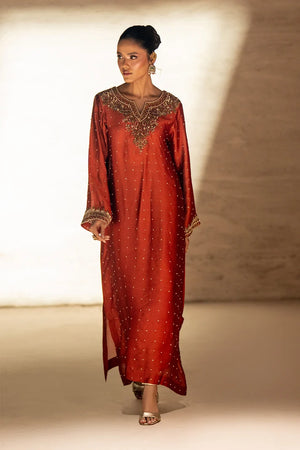 Model wearing deep rust kaftan dress price in pakistan set, sheesha silk kaftan with antique gold embroidery, front view from Buraqstore
