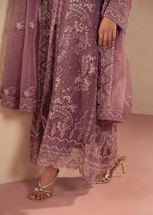Model wearing purple dress design as a festive outfit, shop the embroidered net 3-piece set at Buraqstore