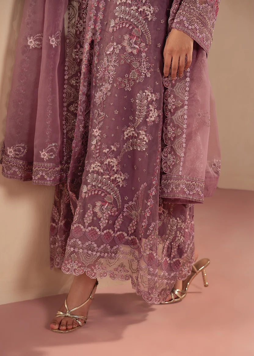 Model wearing purple dress design as a festive outfit, shop the embroidered net 3-piece set at Buraqstore