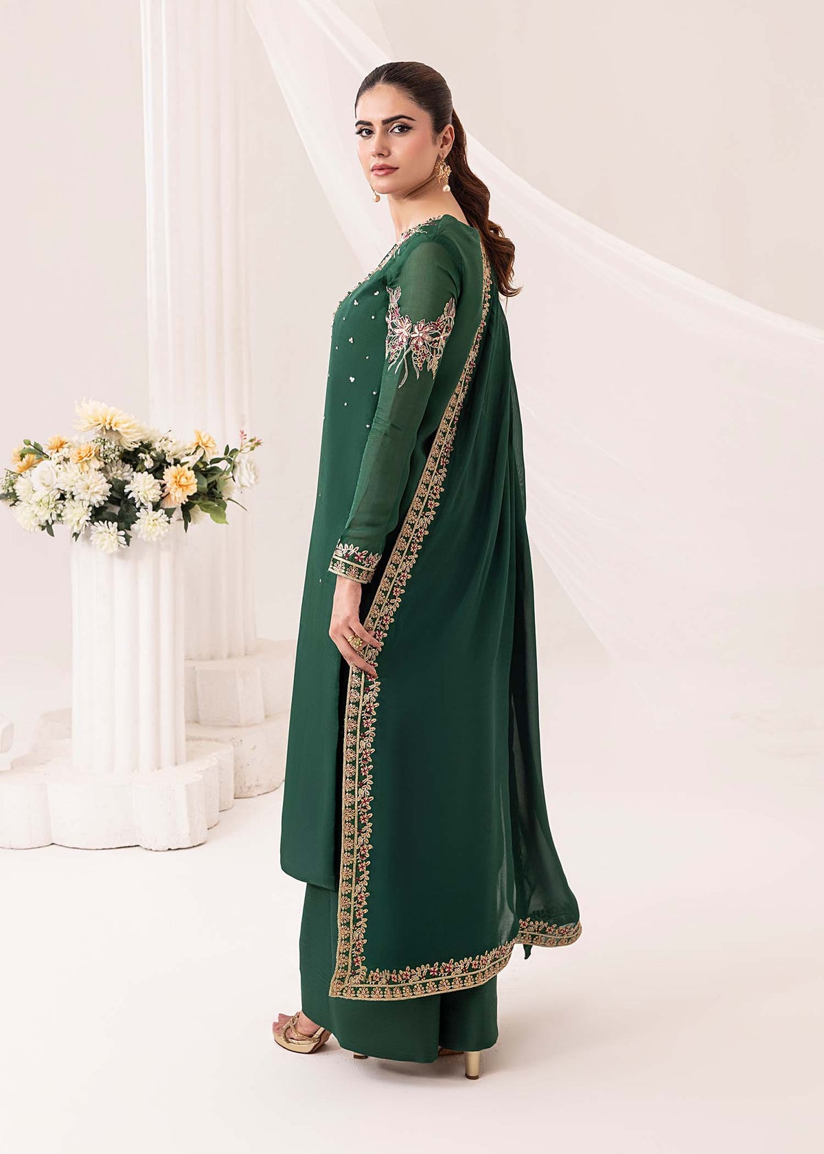 Model showcasing an emerald dark green Jamnii silk 3 piece suit at Buraq Store