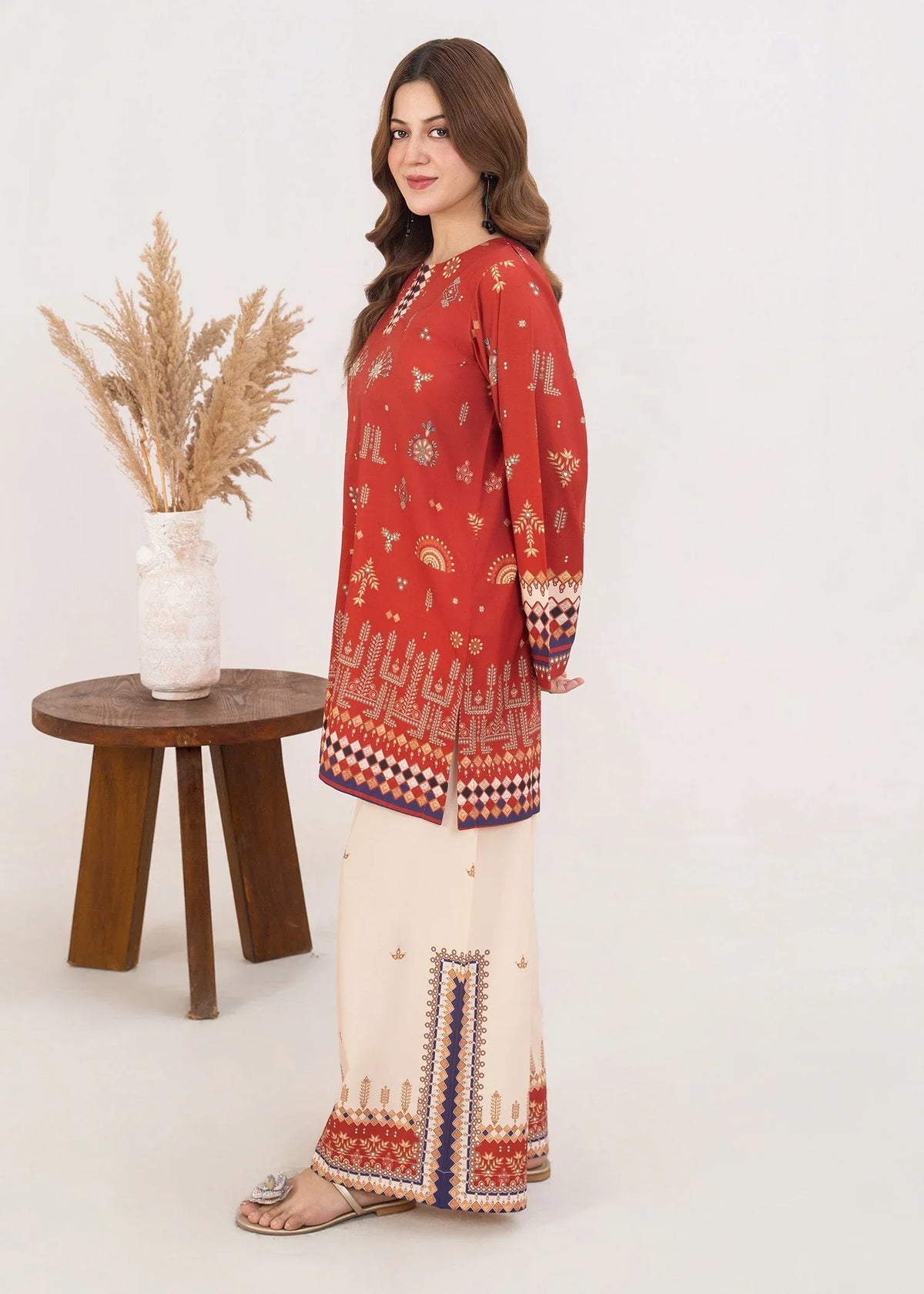 Women wearing orange colour dress, close-up of the print on the poly lawn shirt, Buraqstore
