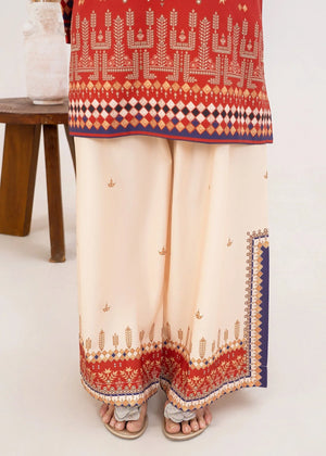 Model wearing orange colour dress as a bold outfit, shop printed poly lawn 2PC set at Buraqstore