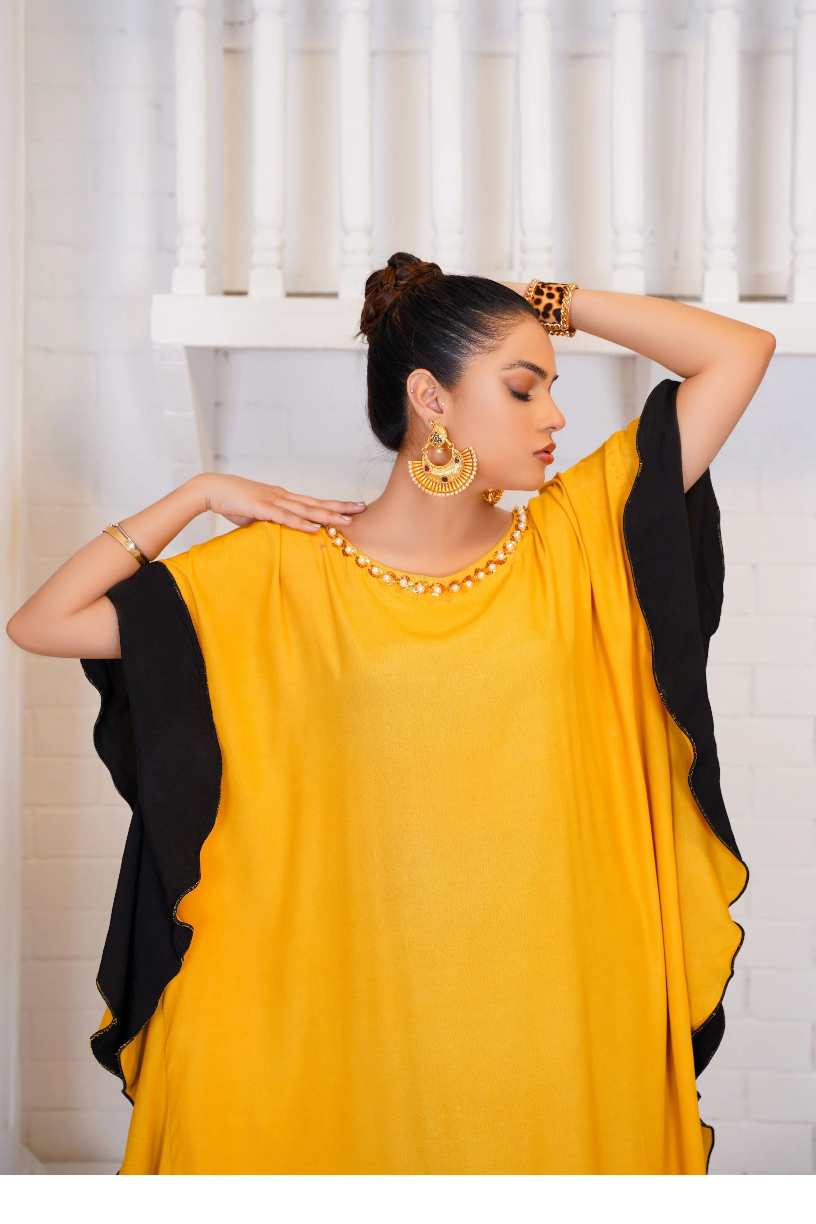 Girl dressed in yellow kaftan by Buraqstore elegant georgette pret wear