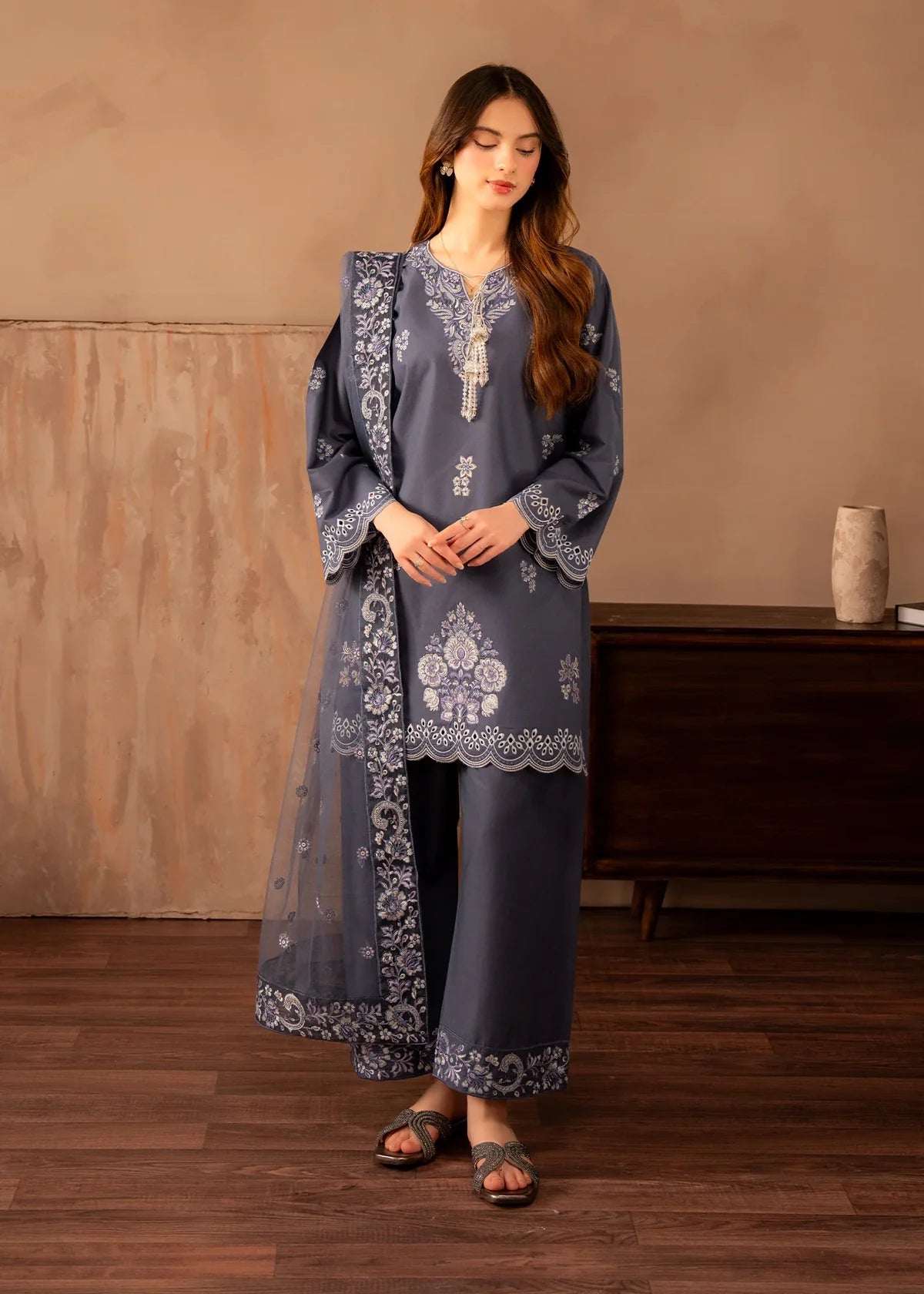 Model wearing grey colour dress, an embroidered lawn shirt and trouser 3PC set with a net dupatta, front view from Buraqstore