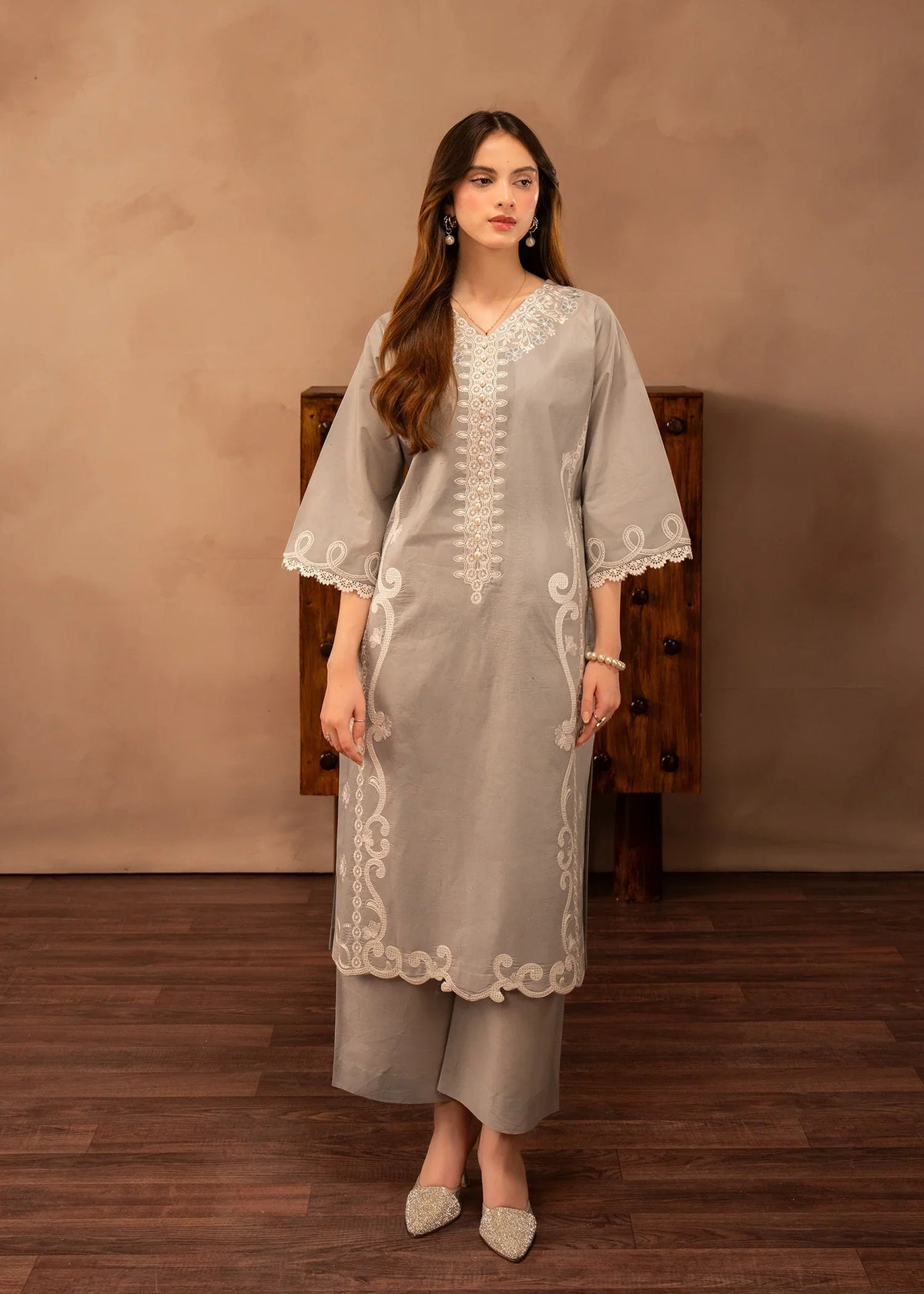 Model wearing simple lawn dress design in grey, embroidered 2PC set, front view from Buraqstore