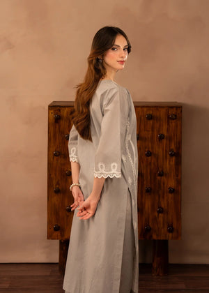 Model wearing simple lawn dress design, side view showing the fit of the embroidered 2PC, Buraqstore
