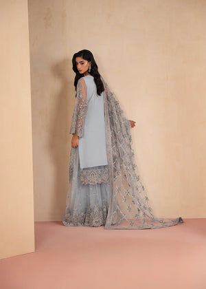 Woman wearing ice blue color dress, close-up of the embroidery and embellishment on the shirt, Buraqstore