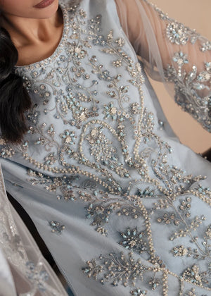 Model wearing ice blue color dress, side view showing the flare of the gharara, Buraqstore