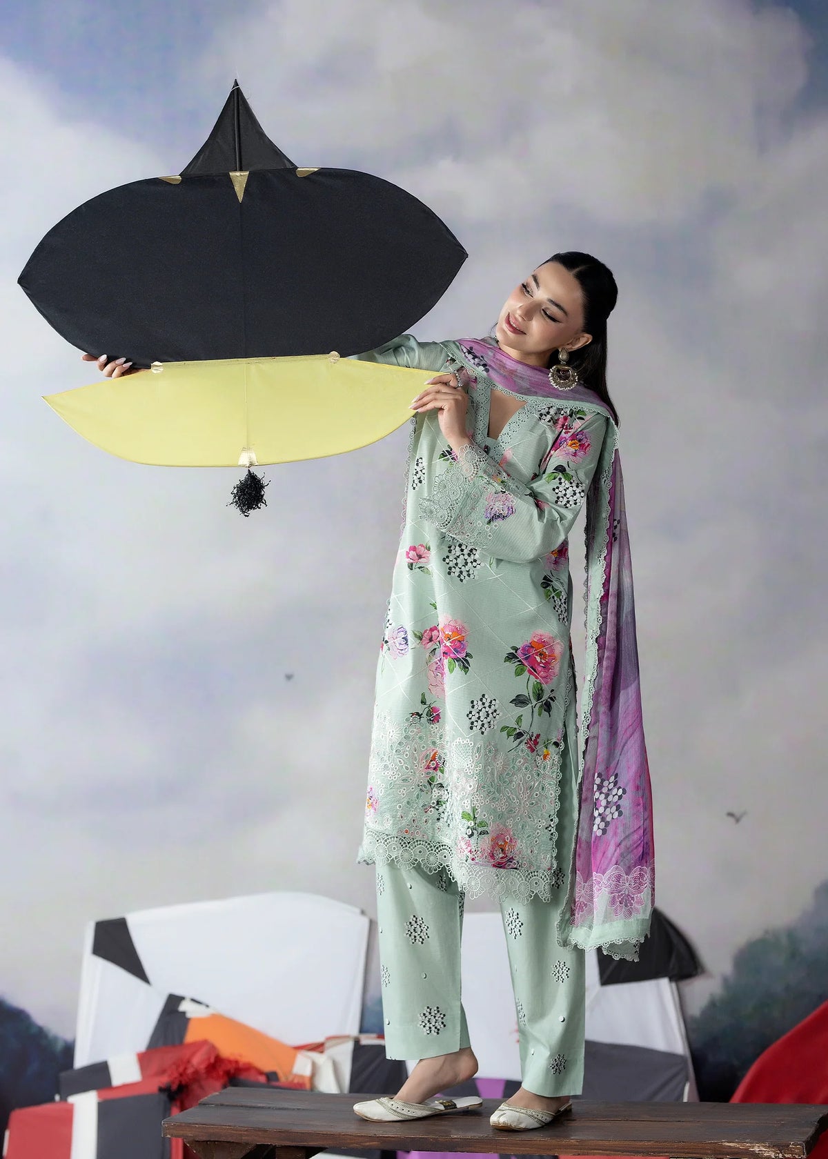 Woman wearing a light green Meerak embroidered lawn suit from Buraq Store
