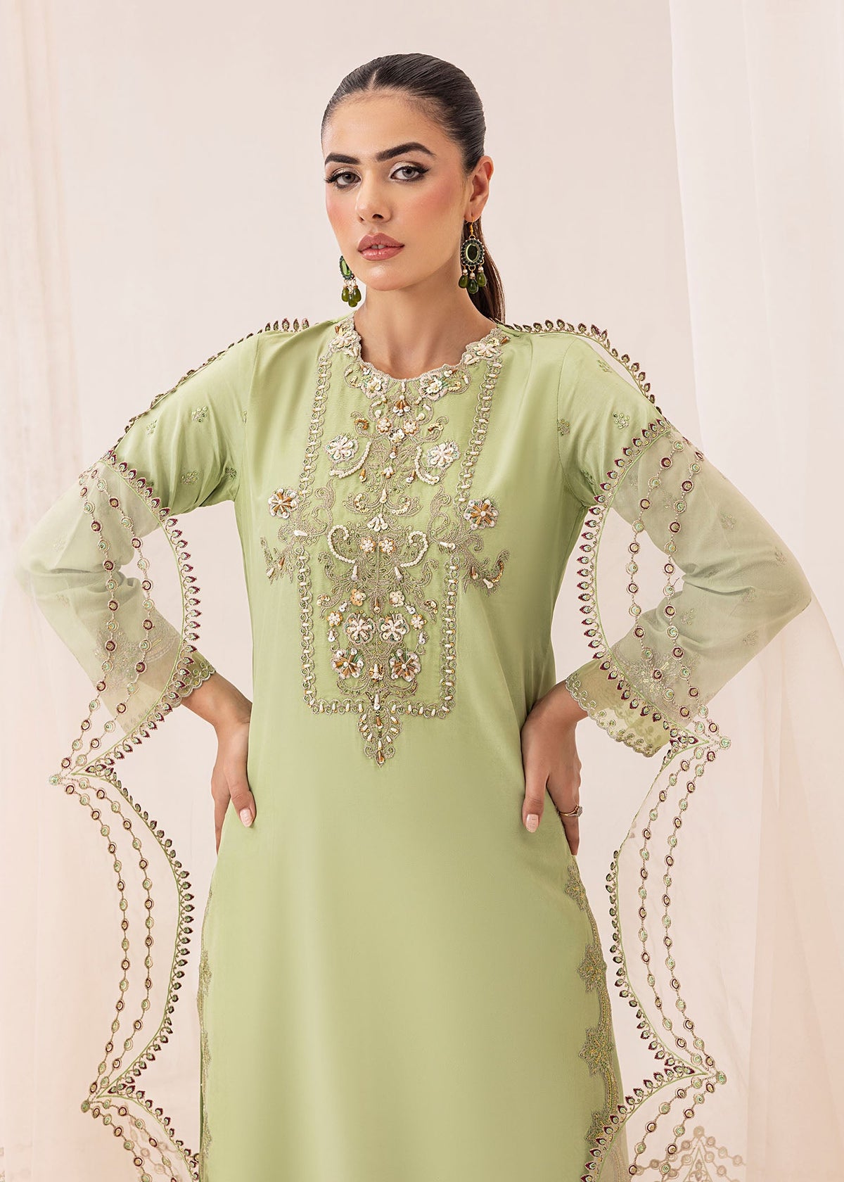 Model showcasing a light green Jamnii silk 3 piece suit at Buraq Store