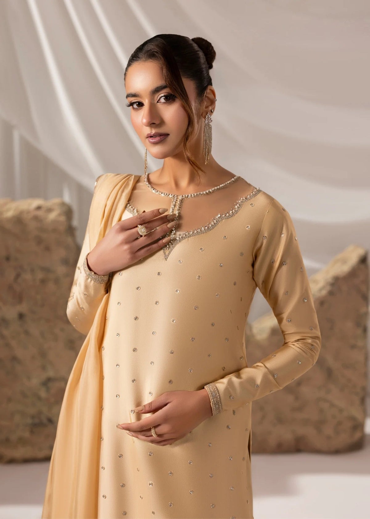 Model showcasing a light yellow Jamnii embroidered silk suit at Buraq Store