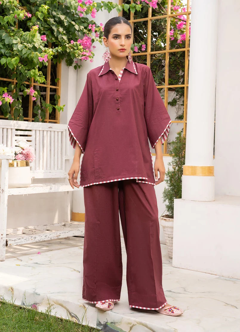 Model wearing maroon dress for women, a cotton co-ord top and bottom with dori and lace detailing, front view from Buraqstore