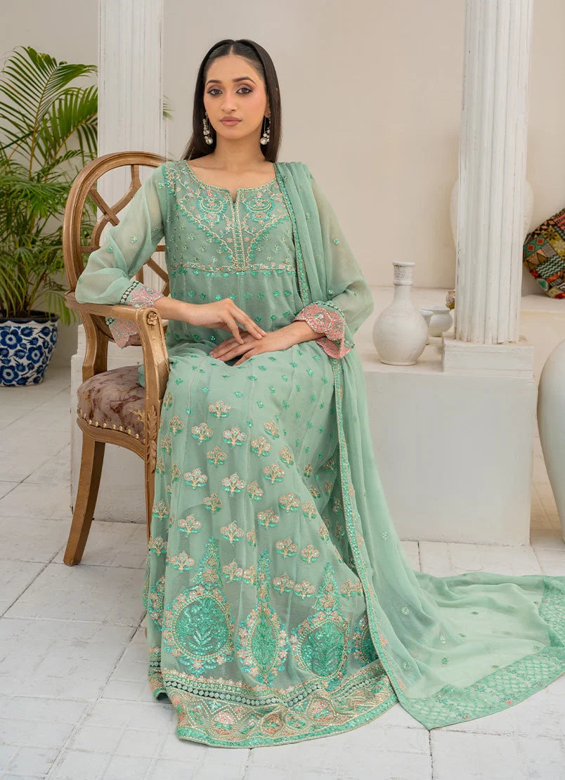 Model wearing light green color dress as a festive outfit, shop the embroidered chiffon 3-piece set at Buraqstore