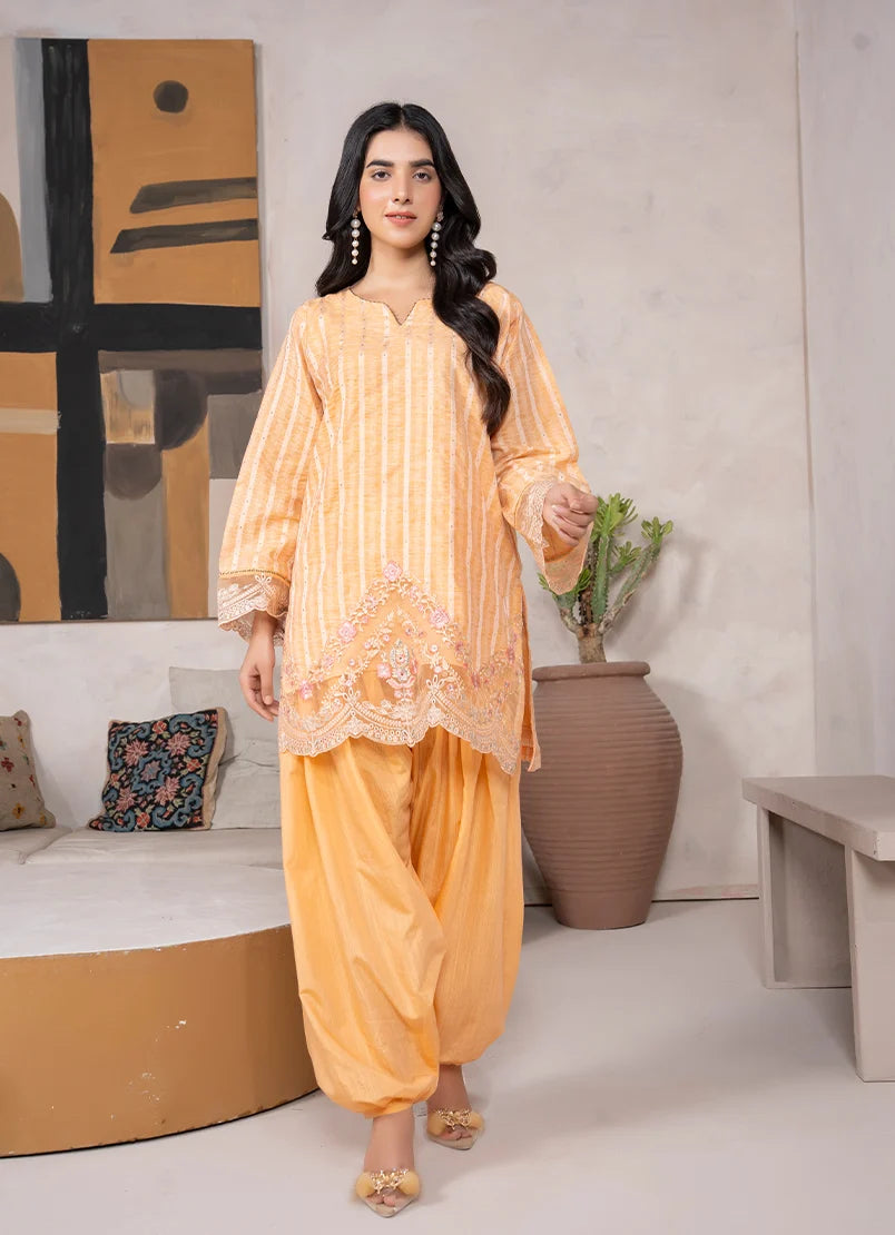 Model wearing yellow dress for women in mustard, embroidered jacquard shirt and bottom, front view from Buraqstore
