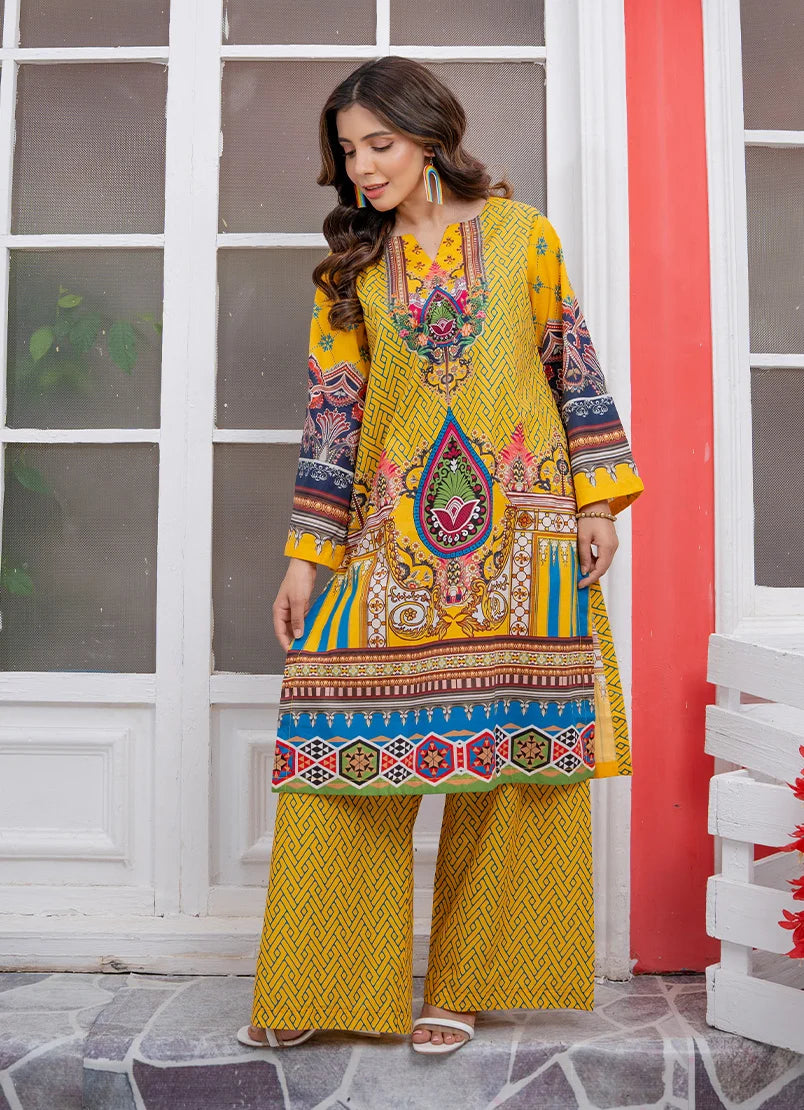 Model wearing yellow dress for women in mustard, a printed lawn shirt and trouser, front view from Buraqstore