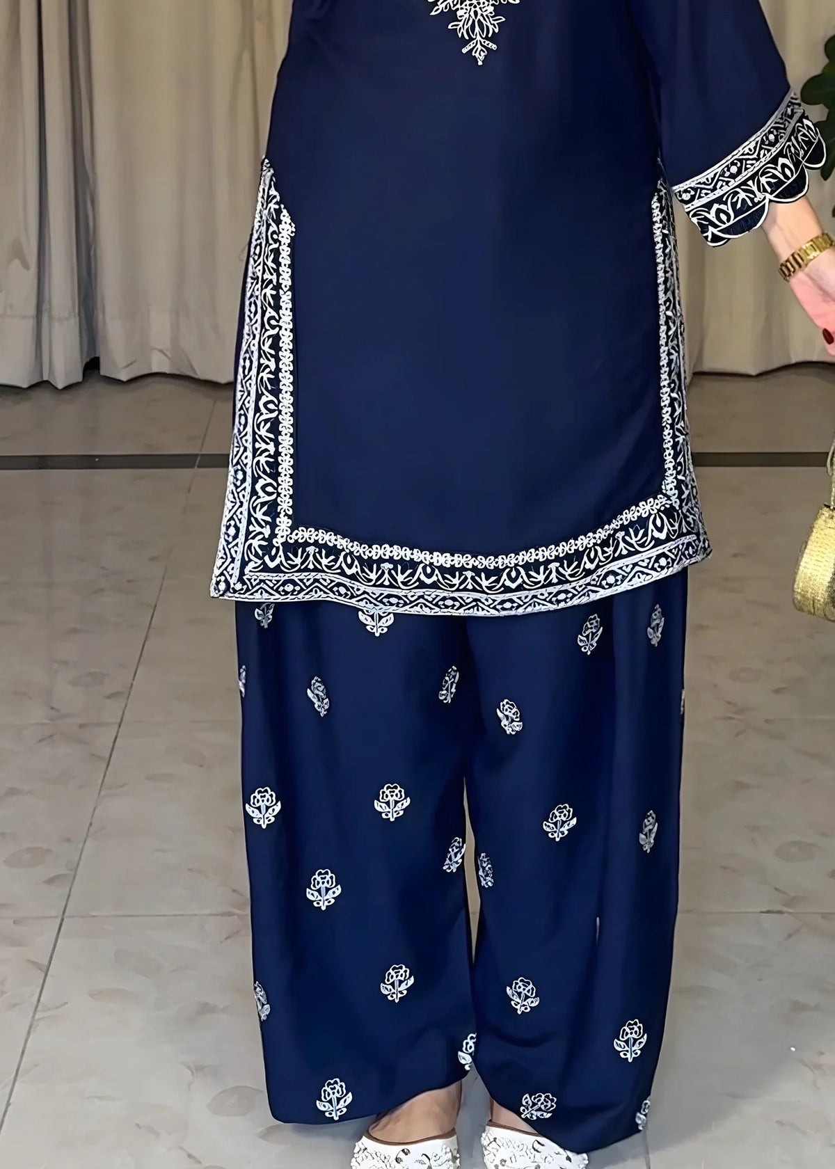 Model wearing navy blue dress, side view showing the fit of the embroidered lawn 2PC, Buraqstore