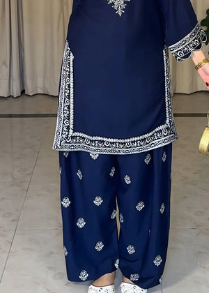 Model wearing navy blue dress, side view showing the fit of the embroidered lawn 2PC, Buraqstore
