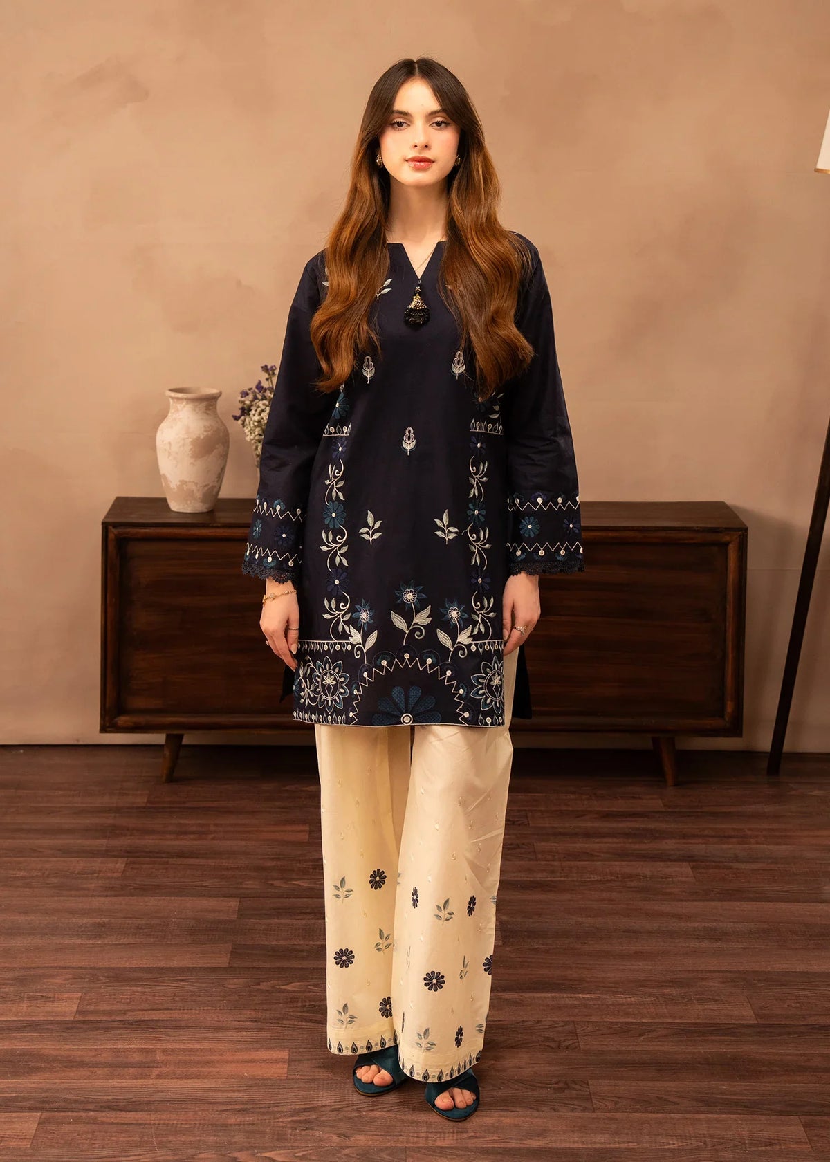 Model wearing navy blue dress pakistani finished in white, embroidered lawn 2PC set, front view from Buraqstore