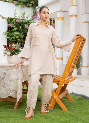 Model wearing co ord set pakistan style in off white, a cotton top and bottom with dori and lace detailing, front view from Buraqstore