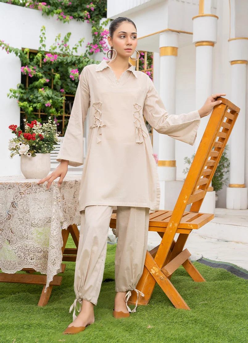 Model wearing co ord set pakistan style in off white, a cotton top and bottom with dori and lace detailing, front view from Buraqstore