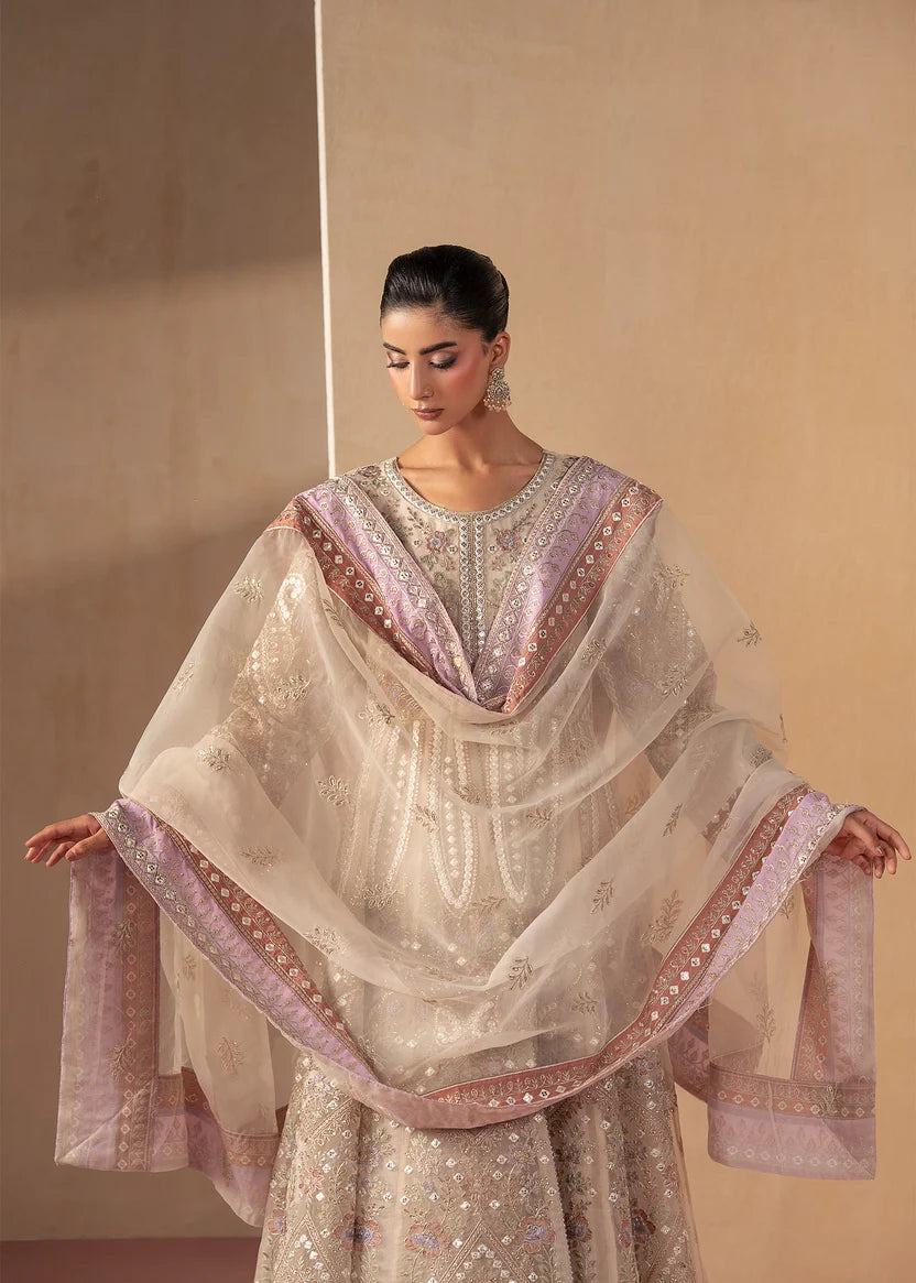 Woman wearing off white dress, close-up of the embroidery and embellishment on the maxi fabric, Buraqstore