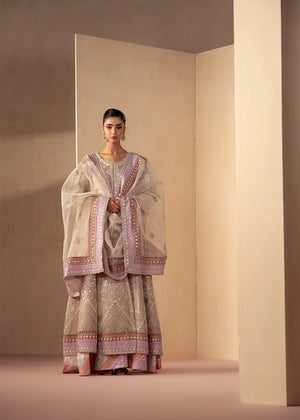 Model wearing off white dress, an embroidered and embellished maxi, front view from Buraqstore