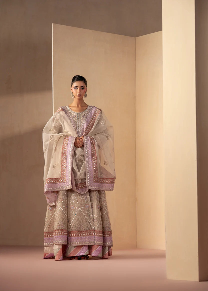 Model wearing off white dress, an embroidered and embellished maxi, front view from Buraqstore