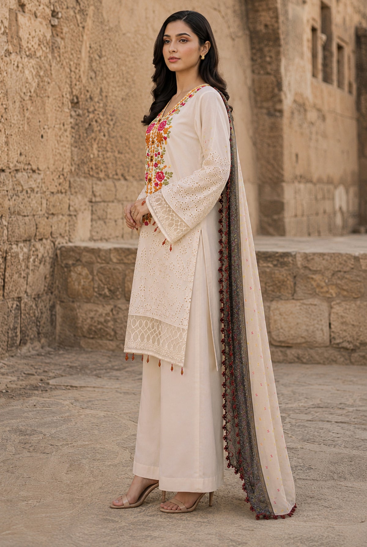 Model wearing off-white chikankari suit sale with price set with plain dyed viscose trouser, side view at Buraqstore