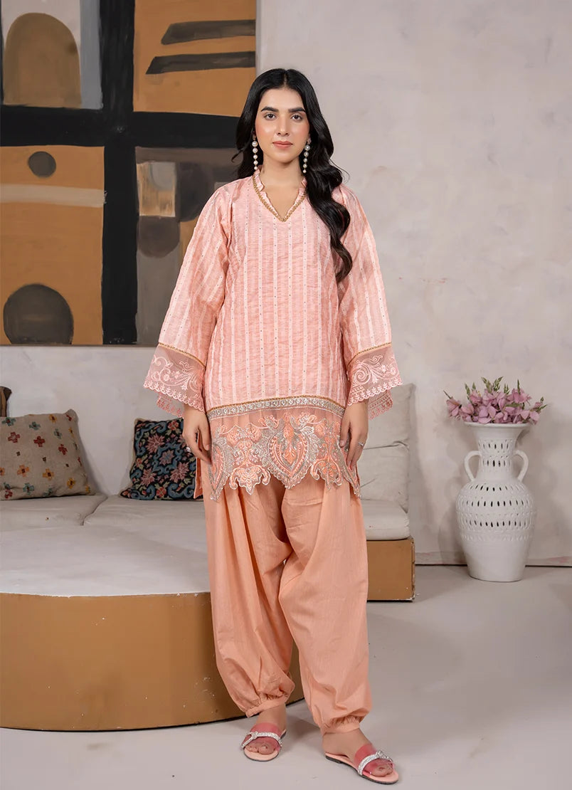 Model wearing peach color dress, an embroidered jacquard shirt and bottom, front view from Buraqstore 