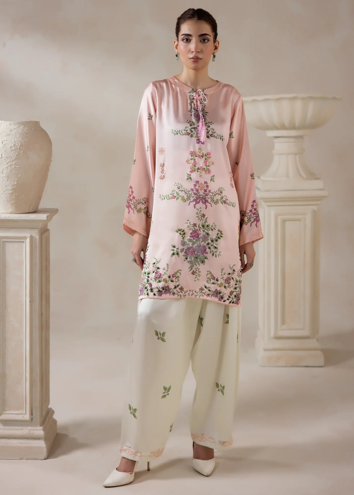 Model wearing silk co ord set for women in pink, a printed charmeuse silk top and bottom, front view from Buraqstore