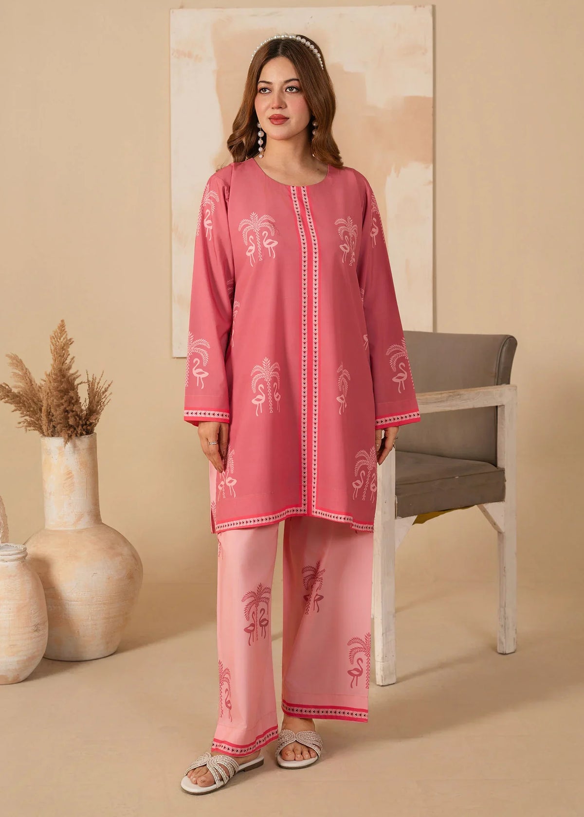 Model wearing pink dress design for girl, printed grip 2PC set, front view from Buraqstore