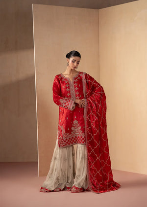 Model wearing red colour dress pakistani in red and beige, embroidered silk shirt with chiffon trouser, front view from Buraqstore